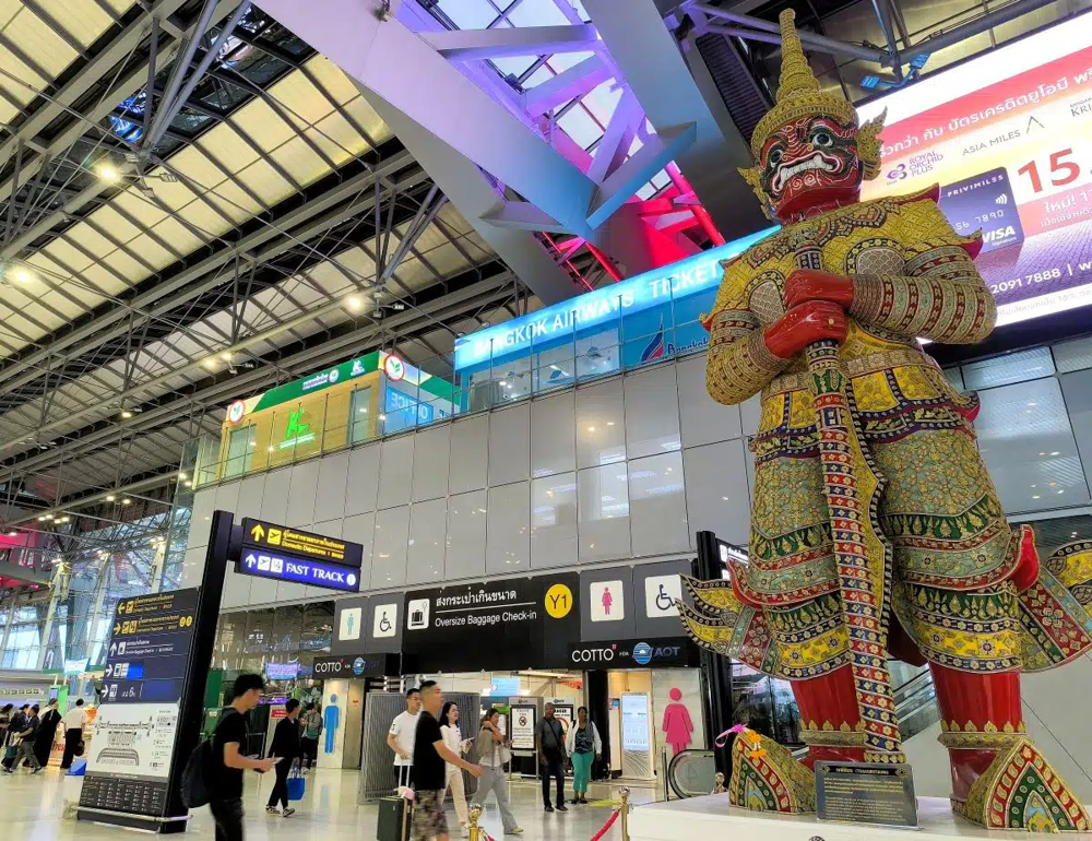 a giant Yaksha statue at Suvarnabhumi Airport welcomes arriving passengers.